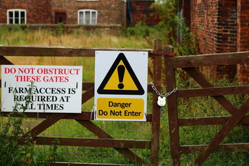 Warning sign on a farm yard gate 