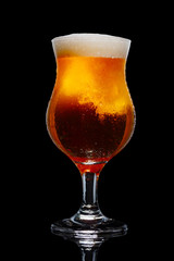 Glass of beer isolated on black background.