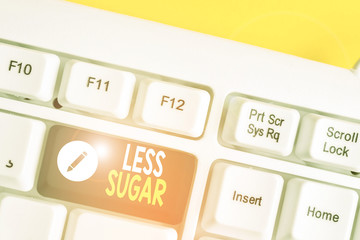 Writing note showing Less Sugar. Business concept for Lower volume of sweetness in any food or drink that we eat White pc keyboard with note paper above the white background