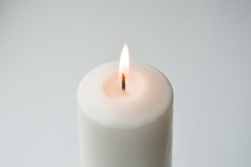 Fototapeta na wymiar white candle on a light background. white. a large candle.