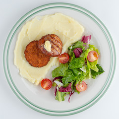 Fototapeta na wymiar Chicken patties with mashed potato and vegetable salad isolated on white flat lay