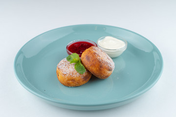 Cottage cheese pancakes with sour cream and berry jam isolated on white flat lay