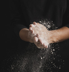 Fototapeta premium Close-up baker hands full of flour