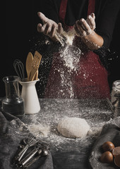 Front view baker hands spreading flour