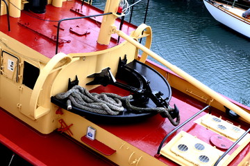 Tugboat pulling hook and rope situated at the stern of the ship