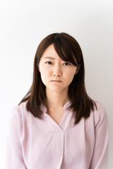 Angry business woman against white background