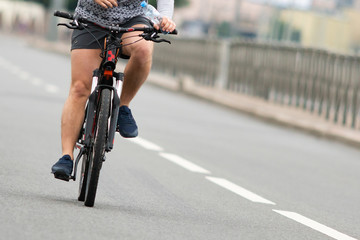Fototapeta na wymiar Cyclist on a city road. Close-up