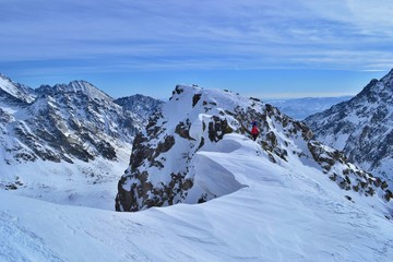 Fototapeta na wymiar Tatra mountains, Slovakia - FEBRUARY 23, 2019: A group of friends is climbing to the summit of Koprovsky Stit. Rising through the snow with cats and wands high in the mountains.