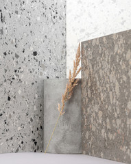 Modern interior composition using various stone textures and dry plants.