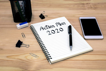 2020 action plan in a notebook with a pen