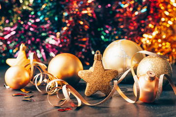 Traditional Christmas toys stars balls of gold color on a sparkling holiday background. New year christmas concept.