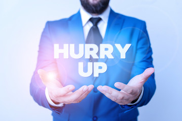 Text sign showing Hurry Up. Business photo showcasing asking someone to do a job very fast Quickly Lets go Encourage Man with opened hands in fron of the table. Mobile phone and notes on the table