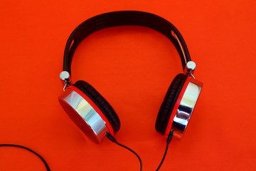headphones on a red background for listening to music