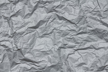 Crumpled gray craft paper texture background. Package wrapping. Old wrapping paper. Baking parchment. Letter template.