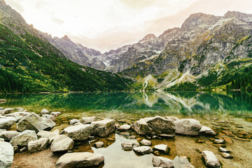 Mountain landscape with view of wonderful  sunrise of Morskie Oko (Sea Eye) lake. Amazing morning in High Tatras National Park, Poland, Europe.  Beauty of nature concept.
