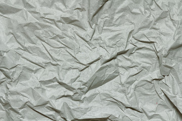 Crumpled gray craft paper texture background. Package wrapping. Old wrapping paper. Baking parchment. Letter template.