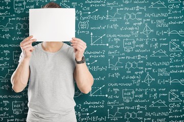 Schoolgirl writes on the blackboard formulas and mathematical equations