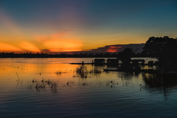 fisherman in a magical sunset in mekong river
