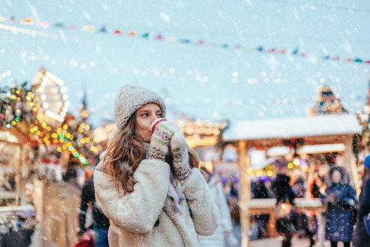 Girl walking on Christmas Market on Red Square in Moscow