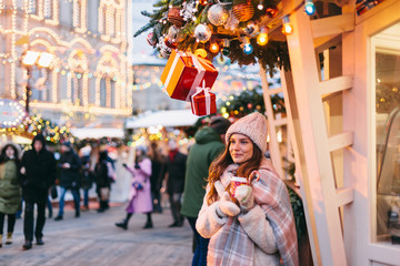 Girl walking on Christmas Market on Red Square in Moscow
