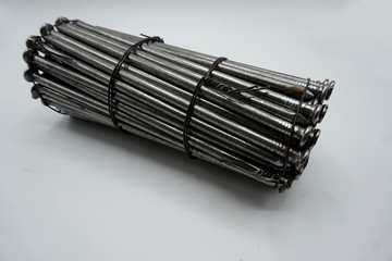 Steel construction nails of different lengths tied together in groups.