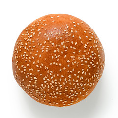 Sesame seed hamburger bun isolated on white. Top view.