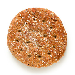 Round oat wheat flat bread isolated on white. Top view.