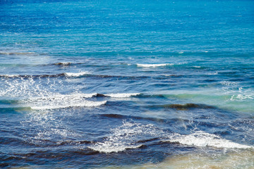 Natural background storm sea blue ocean with foam and waves