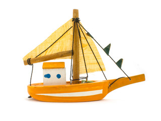 yellow toy small sailing boat on white background