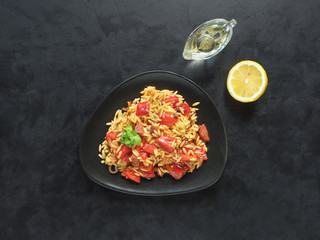 Roasted pepper and chorizo orzo salad combines red peppers, red onion, chorizo and cherry tomatoes with orzo pasta. 