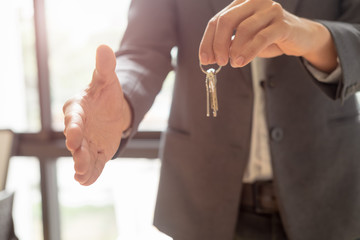 Obraz premium real estate agent shaking hands to his client after signing contract agreement in office,concept for real estate, moving home or renting property