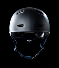 Black skater helmet on black background