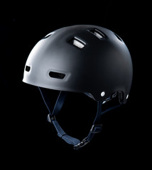 Black skater helmet on black background