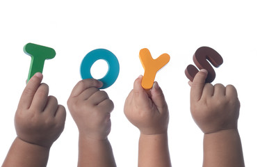 Kids hands holding colorful alphabet letters ,The Word TOYS