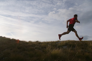 Fototapeta na wymiar Trail running man jumping in the sky