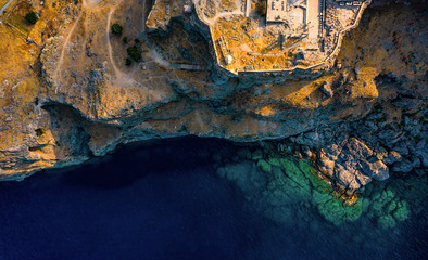 Aerial birds eye view photo taken by drone of iconic Acropolis of village of Lindos, Rhodes island, Dodecanese, Greece.