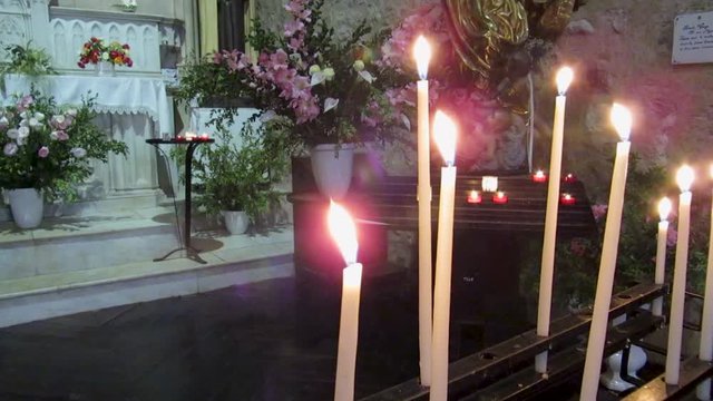 Candle lights in the church of Moustiers-Sainte-Marie in the French Provence