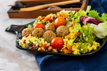 Salad with semolina, Falafels Pickled vegetables and raisins Sauce