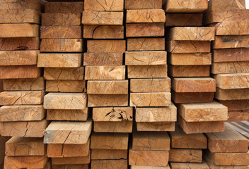 Lumber warehouse. Wooden boards are stacked. Wood texture, background