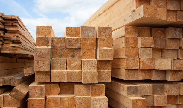 Lumber Warehouse. Wood Planks And Timber Stacked In Stacks Outdoors