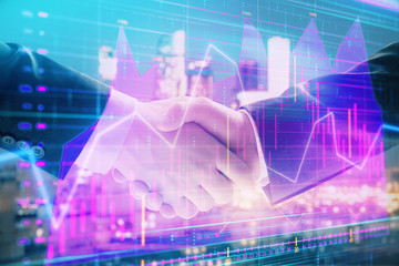 Double exposure of financial chart on cityscape background with two businessmen handshake. Concept of financial analysis and investment opportunities
