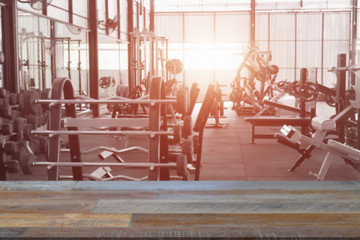 Empty top of fitness gym and wooden deck tabletop.For product display
