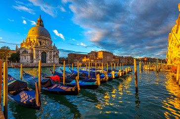 Sunrise view of Canal Grande with Venice gondola and Basilica di Santa Maria della Salute in Venice, Italy