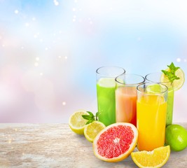 Tasty fruits  and juice with vitamins on background