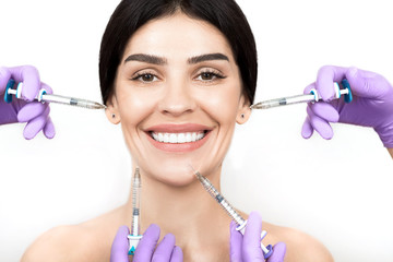 woman advertising concept of skin rejuvenation using beauty injection isolated on white. lot of syringes around a female face. non-surgical cosmetology