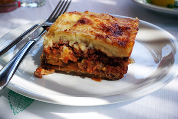 moussaka with aubergine on a dish. traditional greek meal on a table