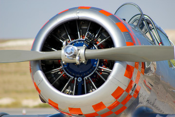 Close up of airplane turboprop engine with propeller, parts of aircraft fuselage, wings and tail 