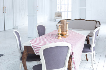 A spacious bright living room with a stylish modern design with elements of antique decor and beautiful chic furniture