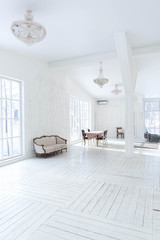 A spacious bright living room with a stylish modern design with elements of antique decor and beautiful chic furniture