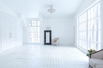 A spacious bright living room with a stylish modern design with elements of antique decor and beautiful chic furniture